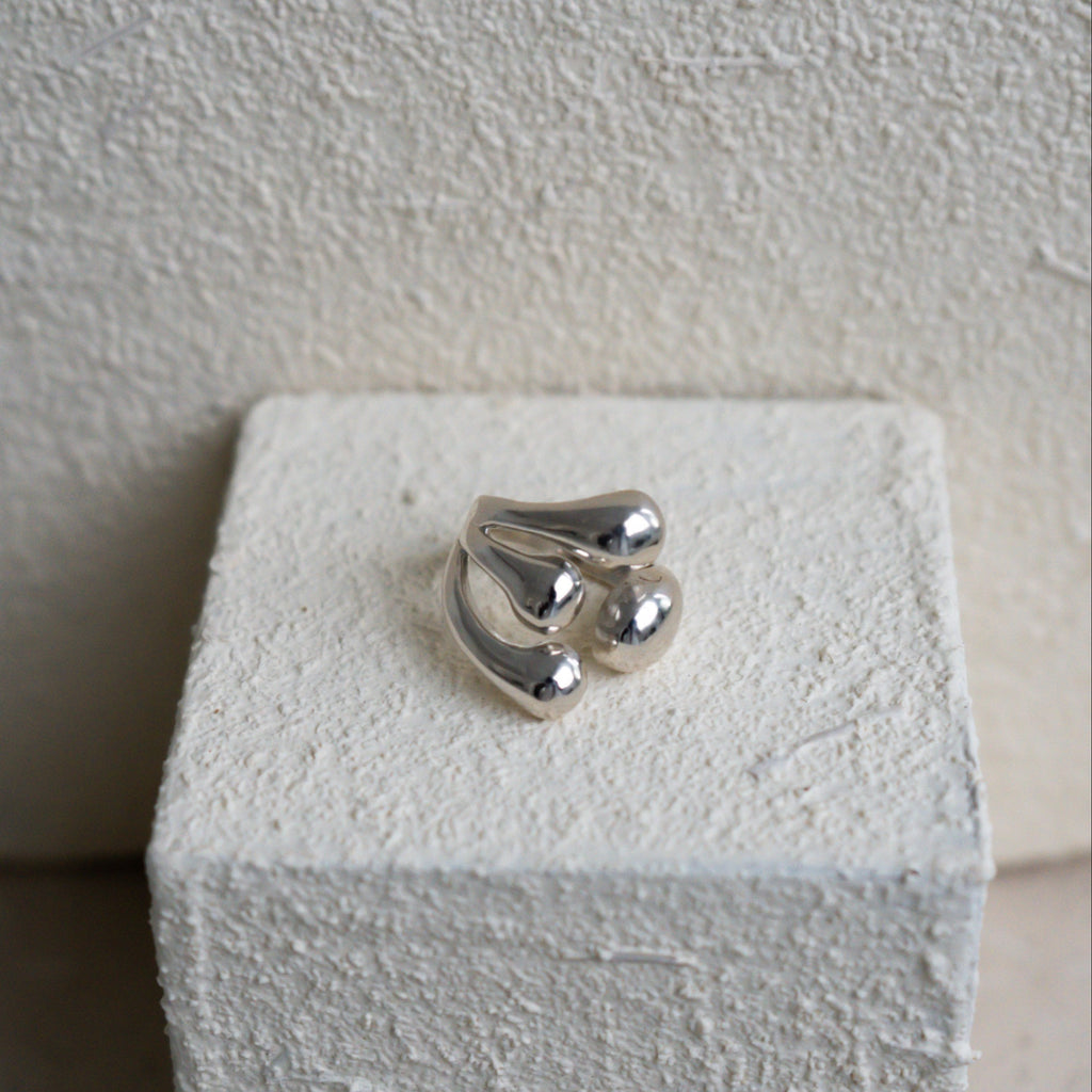 Silver ring on a white stone surface