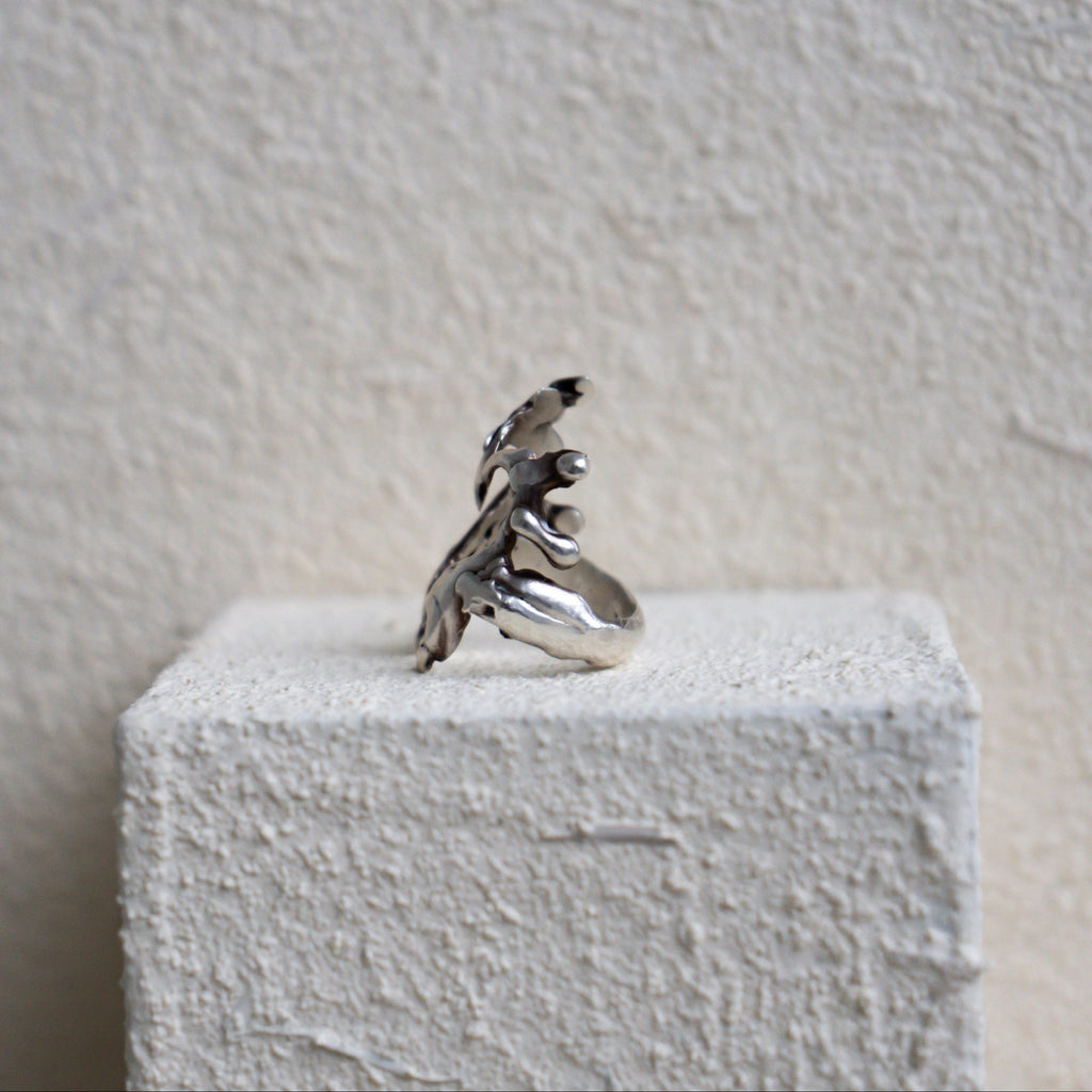 Silver ring on a textured white surface